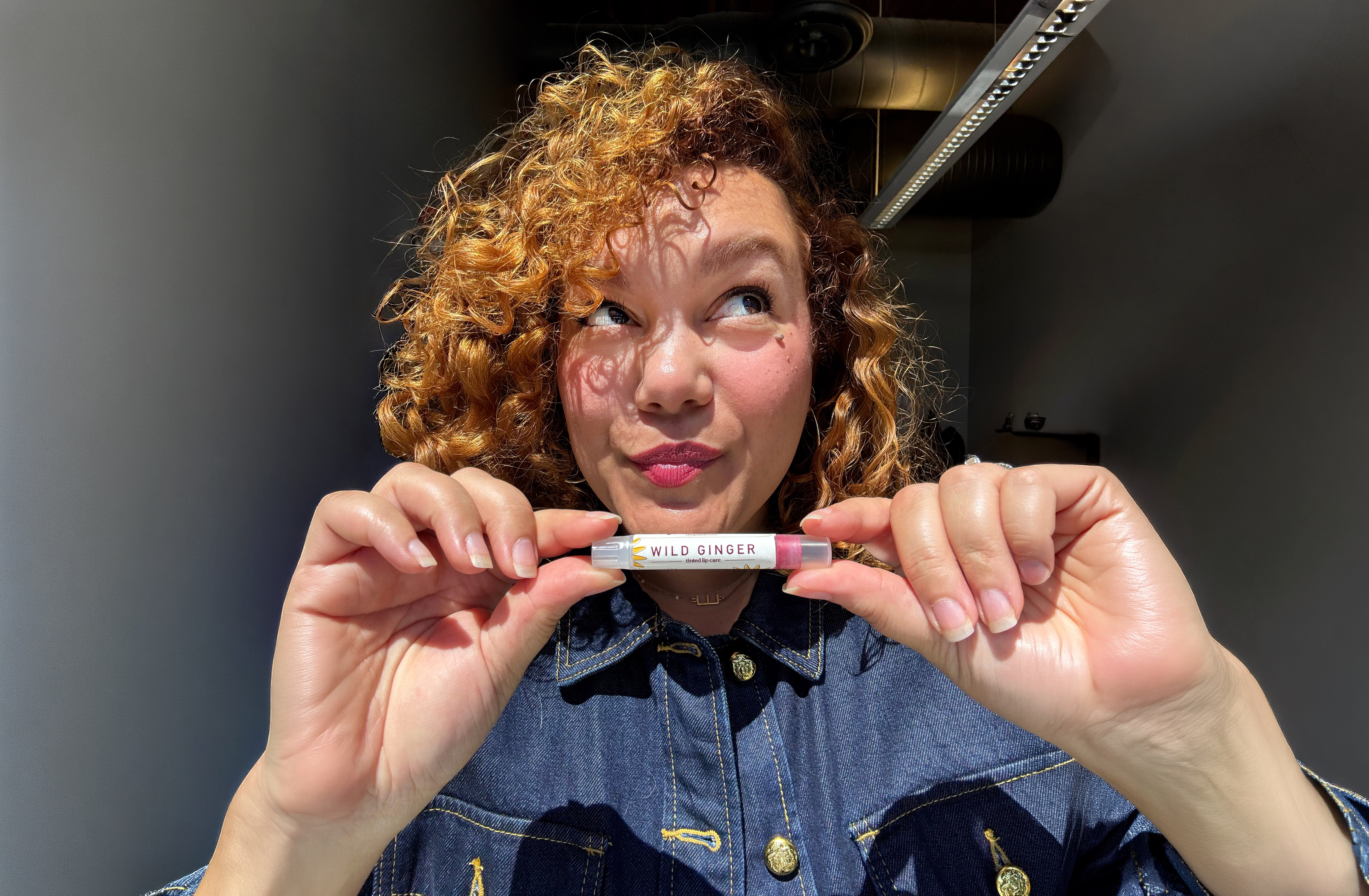 Wild Ginger tinted ChopSaver lip care held near tinted lips